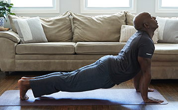 African American man performing a yogo